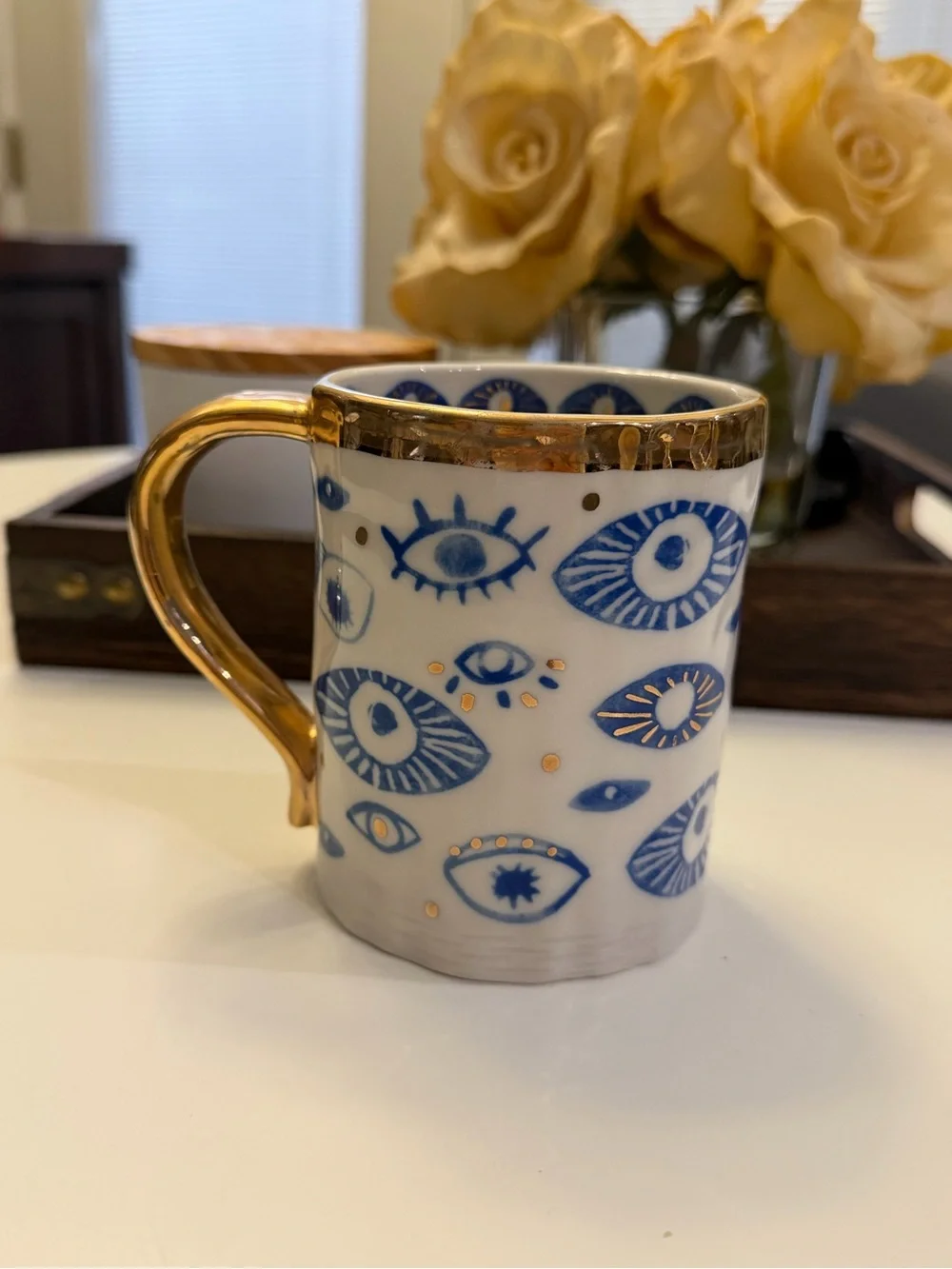 Anthropologie White Ceramic Mug with Blue Eye Motif and Gold Trim